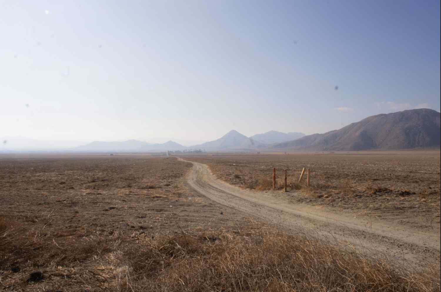 A lone dirt road cuts through the desert in Riverside County, Calif